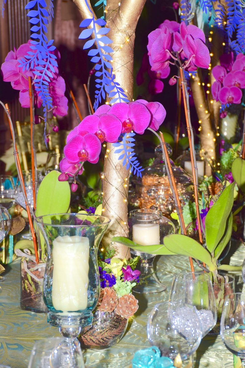 Purple orchid formal dining table arrangement at Longwood Gardens. This was a large dining room table set with crystal vases and blinking white Christmas at Longwood’s December Christmas Festival.